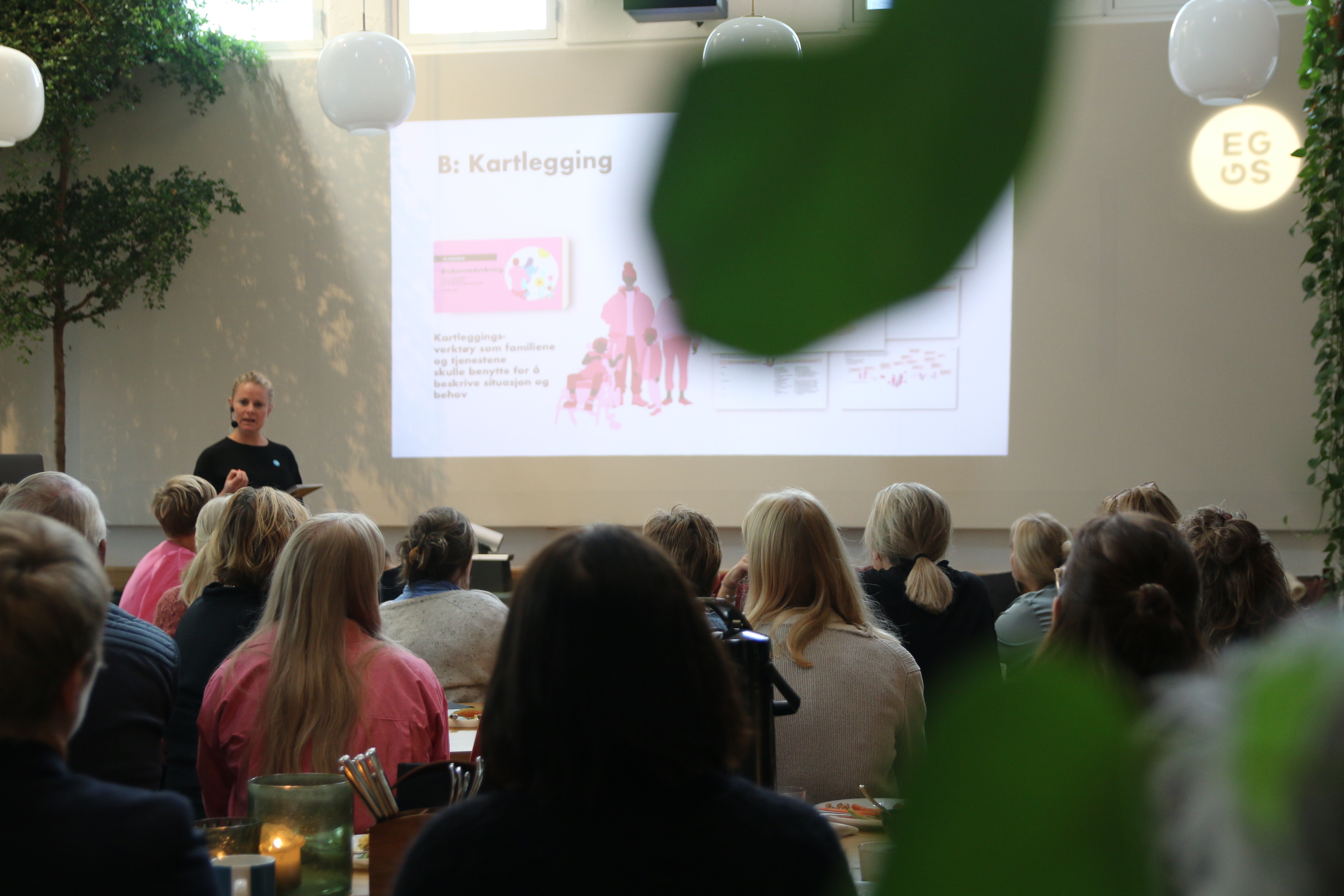 Event image showing a speaker and her audience